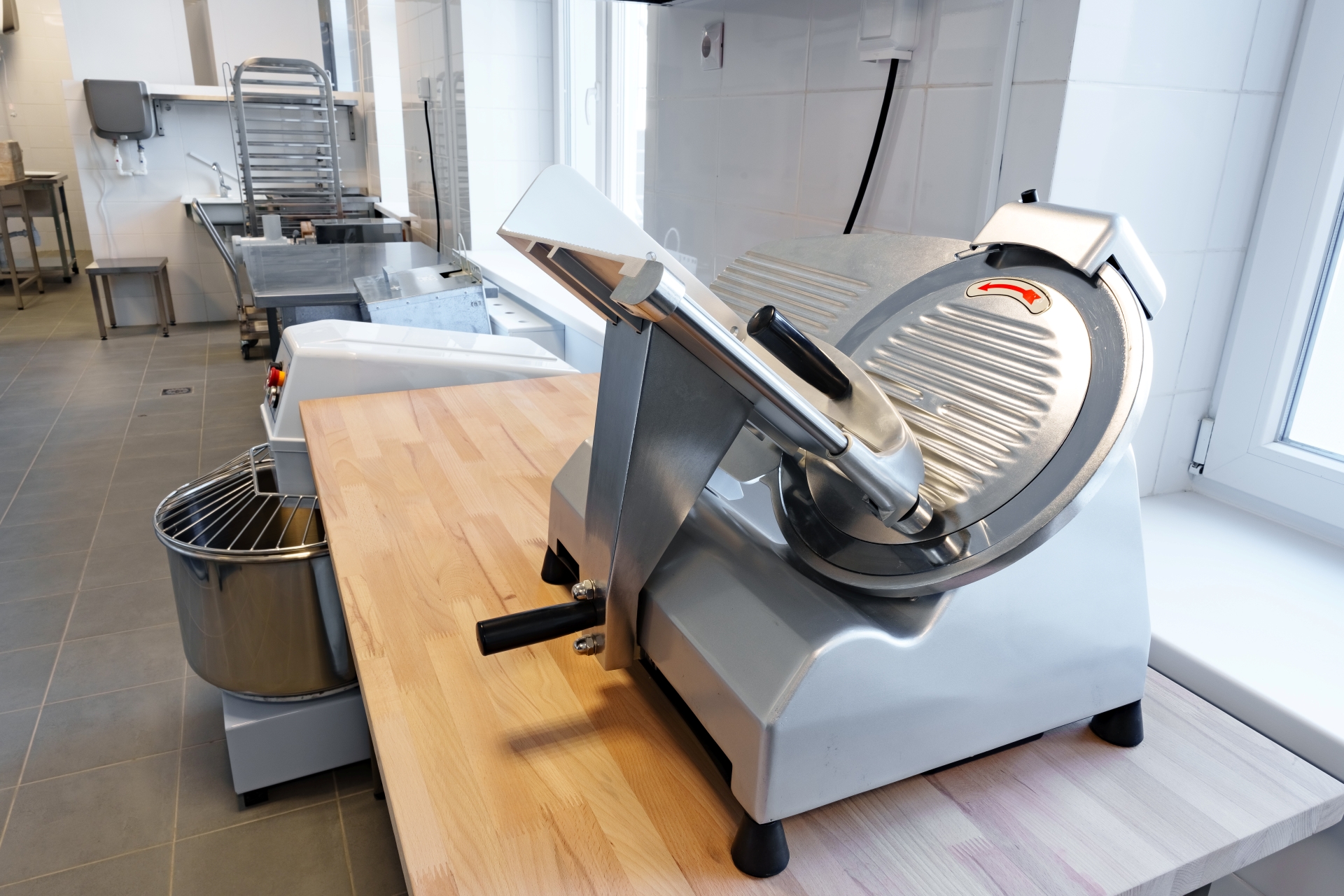 High-quality meat slicer positioned in a modern kitchen designed for culinary professionals